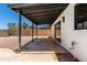 Spacious covered patio featuring a concrete base, access to the backyard, and a sliding glass door at 2220 S Cottonwood Dr, Tempe, AZ 85282