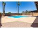 Outdoor pool area with palm trees, rock landscaping, and a concrete deck surrounding the cool blue water at 2220 S Cottonwood Dr, Tempe, AZ 85282