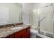 Bathroom with granite countertop vanity and glass-enclosed shower at 22417 W Loma Linda Blvd, Buckeye, AZ 85326