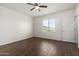 Bedroom featuring wood-look tile flooring, neutral walls, and a ceiling fan at 22417 W Loma Linda Blvd, Buckeye, AZ 85326
