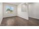 Bedroom featuring wood-look tile flooring, window with blinds, and neutral walls at 22417 W Loma Linda Blvd, Buckeye, AZ 85326
