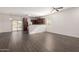Open-concept living area with wood-look tile flooring and sliding glass doors to the backyard at 22417 W Loma Linda Blvd, Buckeye, AZ 85326
