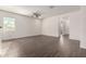 Open-concept living area with wood-look tile flooring and a ceiling fan at 22417 W Loma Linda Blvd, Buckeye, AZ 85326