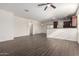 Bright, open-concept living space with sleek tile floors, leading to a modern kitchen with ample natural light at 22417 W Loma Linda Blvd, Buckeye, AZ 85326