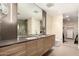 Well-lit bathroom featuring double sinks, modern cabinets, and large mirrors at 2300 E Campbell Ave # 114, Phoenix, AZ 85016