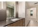 Elegant bathroom features a modern vanity and tiled mirror wall with bright cabinetry at 2300 E Campbell Ave # 114, Phoenix, AZ 85016