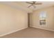 Cozy bedroom with plush carpeting, modern ceiling fan, and window view at 2300 E Campbell Ave # 114, Phoenix, AZ 85016