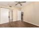 Neutral bedroom features modern ceiling fan and doors that lead to other rooms at 2300 E Campbell Ave # 114, Phoenix, AZ 85016