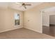 Bedroom featuring neutral carpet, modern ceiling fan and doorway view into other room at 2300 E Campbell Ave # 114, Phoenix, AZ 85016