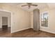 Light filled bedroom shows hardwood floors, concrete column and leads to en-suite bathroom and an outdoor patio at 2300 E Campbell Ave # 114, Phoenix, AZ 85016