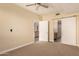Modern bedroom featuring a ceiling fan, carpet, and sliding barn door at 2300 E Campbell Ave # 114, Phoenix, AZ 85016