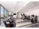 Bright gym featuring cardio equipment with floor-to-ceiling windows and stylish black and gray flooring at 2300 E Campbell Ave # 114, Phoenix, AZ 85016