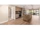 Contemporary kitchen features stainless steel appliances, gas range and a center island, flowing to an open-plan living area at 2300 E Campbell Ave # 114, Phoenix, AZ 85016