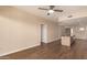 Spacious open-plan living room with a view of the kitchen and stainless steel appliances, designed for modern living at 2300 E Campbell Ave # 114, Phoenix, AZ 85016