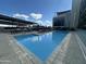 Sparkling community pool with lounge chairs and shaded BBQ area at 2300 E Campbell Ave # 114, Phoenix, AZ 85016