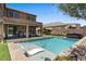 A refreshing backyard pool area with a tanning shelf, spa, and covered patio for relaxing and entertaining at 23081 S 223Rd Way, Queen Creek, AZ 85142