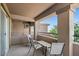 This home has a covered outdoor patio with three chairs and a small table at 23081 S 223Rd Way, Queen Creek, AZ 85142