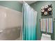 Bathroom features a shower with blue ombre curtains and fun tic-tac-toe art at 23081 S 223Rd Way, Queen Creek, AZ 85142