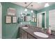 Bathroom boasts dual sinks, gray cabinets, mosaic backsplash, and fun artwork at 23081 S 223Rd Way, Queen Creek, AZ 85142