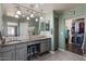 Bathroom boasts dual sinks, gray cabinets, pendant lighting, and a walk-in closet at 23081 S 223Rd Way, Queen Creek, AZ 85142