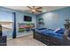 Blue bedroom features a black bedframe, a ceiling fan, and fun decorative details at 23081 S 223Rd Way, Queen Creek, AZ 85142