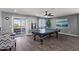 Bright game room featuring hardwood floors, neutral paint, lots of natural light, and a pool table at 23081 S 223Rd Way, Queen Creek, AZ 85142