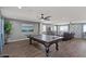 Game room features hardwood floors, neutral paint, lots of natural light, and a pool table at 23081 S 223Rd Way, Queen Creek, AZ 85142