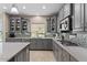 Charming kitchen featuring stainless steel appliances, gray cabinetry, granite countertops, and mosaic backsplash at 23081 S 223Rd Way, Queen Creek, AZ 85142