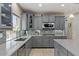 Modern kitchen with grey cabinets, granite counters, tile backsplash, stainless appliances, and plenty of storage at 23081 S 223Rd Way, Queen Creek, AZ 85142