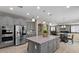 Open kitchen with an island, stainless steel appliances, and view of the dining and living room at 23081 S 223Rd Way, Queen Creek, AZ 85142