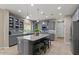 Contemporary kitchen with grey cabinetry, granite countertops and breakfast bar seating at 23081 S 223Rd Way, Queen Creek, AZ 85142