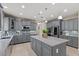 Spacious kitchen features gray cabinets, tile backsplash, granite countertops, and stainless steel appliances at 23081 S 223Rd Way, Queen Creek, AZ 85142