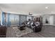 Large living room featuring hardwood floors, gray walls, lots of natural light, and an open entryway at 23081 S 223Rd Way, Queen Creek, AZ 85142