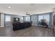 Spacious living room offers dark hardwood floors, neutral walls, lots of natural light, and a ceiling fan at 23081 S 223Rd Way, Queen Creek, AZ 85142