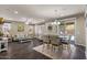 Open living area with wood floors, neutral walls, large windows and dining space at 23081 S 223Rd Way, Queen Creek, AZ 85142