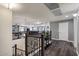 Second story loft area featuring dark hardwood flooring, custom metal railings, and ample natural light at 23081 S 223Rd Way, Queen Creek, AZ 85142