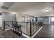 Spacious loft area with hardwood floors, custom metal railings, and views to other rooms at 23081 S 223Rd Way, Queen Creek, AZ 85142