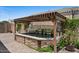 A decorative water feature with stone accents and lush landscaping for serene outdoor living at 23081 S 223Rd Way, Queen Creek, AZ 85142