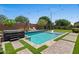 Backyard pool featuring a baja shelf, spa, and artificial turf at 23081 S 223Rd Way, Queen Creek, AZ 85142