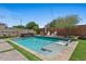 Backyard pool featuring a baja shelf, spa, and artificial turf at 23081 S 223Rd Way, Queen Creek, AZ 85142