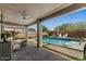 Home's backyard includes a large pool and a covered patio with lounge chairs at 23081 S 223Rd Way, Queen Creek, AZ 85142