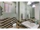 Stylishly designed powder room with modern fixtures, decorative tile, and a pedestal sink at 23081 S 223Rd Way, Queen Creek, AZ 85142