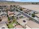 Beautiful aerial view of a residential neighborhood with well-maintained houses, green lawns, and mountain views at 23645 W Parkway Dr, Buckeye, AZ 85326