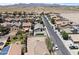 This aerial view showcases a neighborhood with diverse homes and manicured lawns, complete with mountain views at 23645 W Parkway Dr, Buckeye, AZ 85326