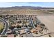 Panoramic aerial view of a neighborhood with houses, streets, and open fields in the background at 23645 W Parkway Dr, Buckeye, AZ 85326
