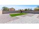 Landscaped backyard featuring a grassy patch, stone pavers, and a playset for outdoor enjoyment at 23645 W Parkway Dr, Buckeye, AZ 85326