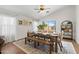 Bright dining room with modern wood table, bench seating, and backyard views at 23645 W Parkway Dr, Buckeye, AZ 85326