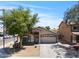 Attractive home with a manicured lawn, mature tree, and convenient two-car garage at 23645 W Parkway Dr, Buckeye, AZ 85326