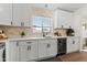 Bright kitchen featuring white cabinets, a beverage cooler, and sleek quartz countertops at 23645 W Parkway Dr, Buckeye, AZ 85326