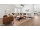 Bright living room featuring stylish furniture, wood floors, and ample natural light at 23645 W Parkway Dr, Buckeye, AZ 85326